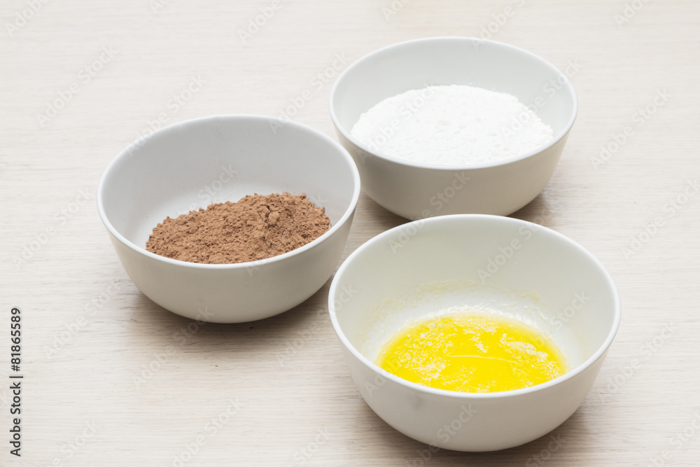 Bowl with home eggs, bowl with cocoa and bowl with milk Bowl with home eggs, bowl with cocoa and bowl with milk