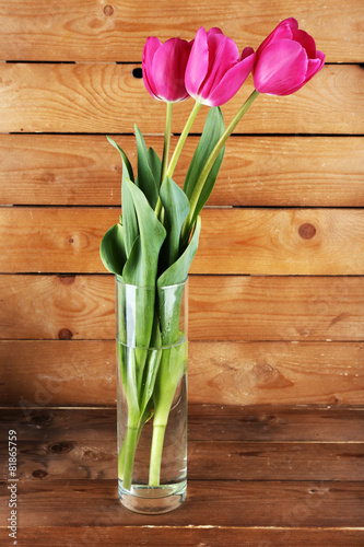 Beautiful tulips on wooden background