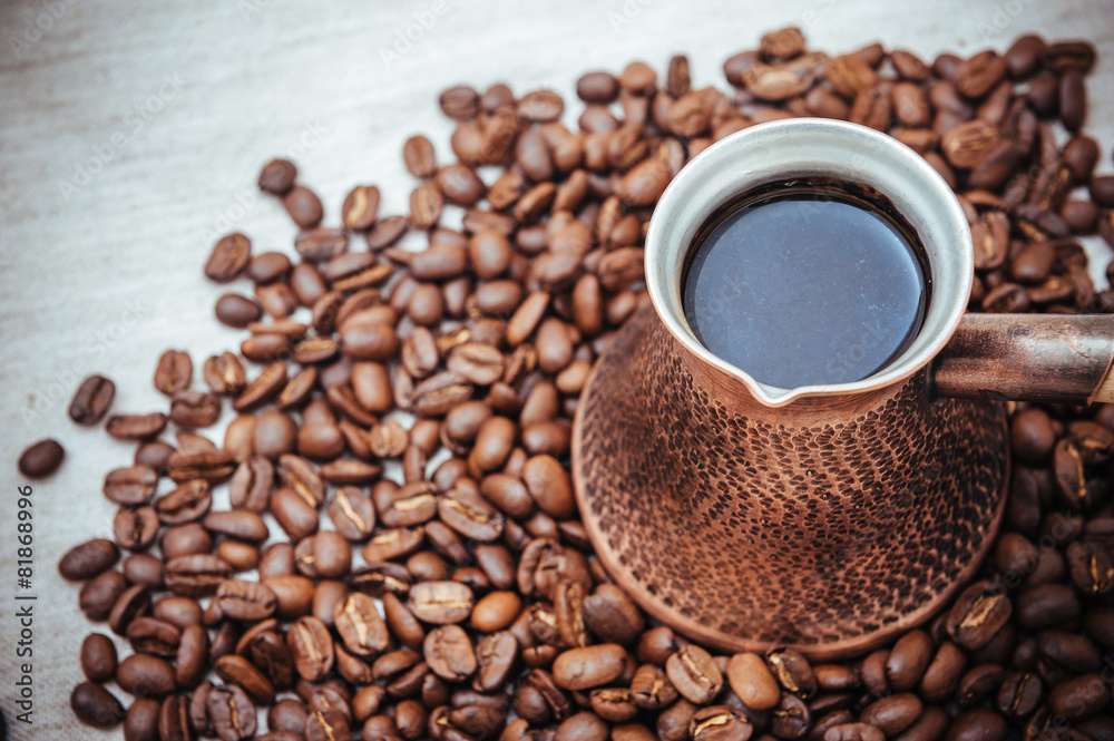 Fototapeta premium Coffee turk and roasted beans on burlap background.
