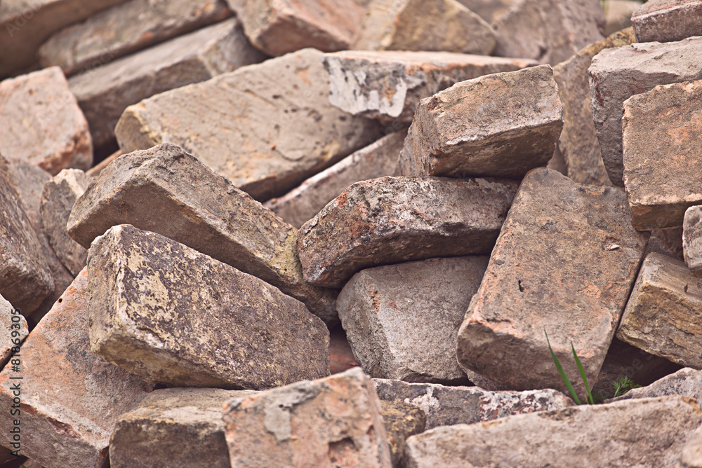 Fototapeta premium Pile of Old Used Bricks as Construction Material