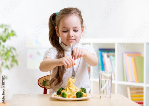 kid eating healthy food at home