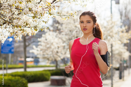 Young beautiful woman running in the city