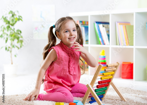 child girl playing with abacus