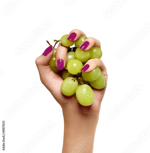 beauty female hand with green grapes  on a white background