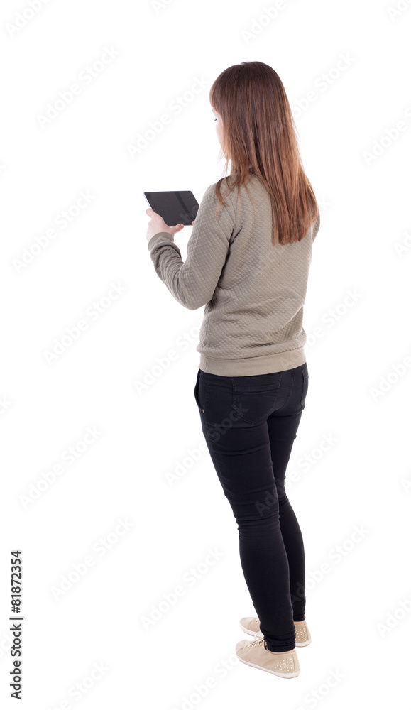 back view of standing young beautiful girl with tablet computer back view of standing young beautiful girl with tablet computer