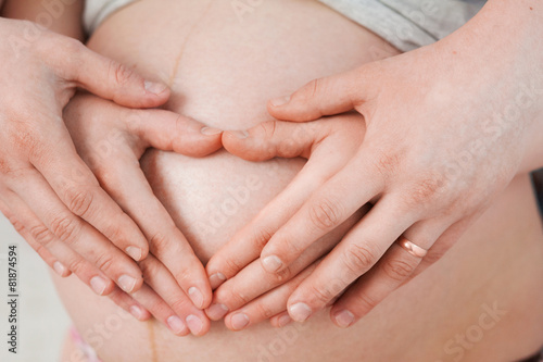 Happy pregnant couple hugging