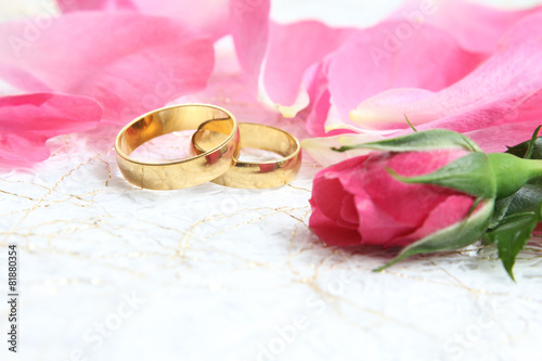 pair of wedding rings with roses for background image photo