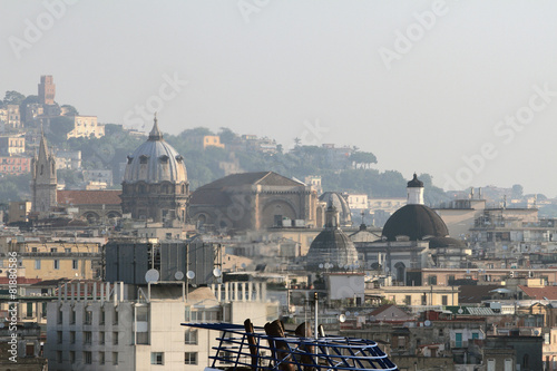 Soaring pipes of motor ship and temples in city. Naples, Italy