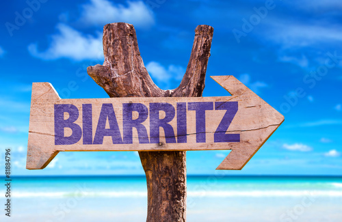 Biarritz wooden sign with beach background photo