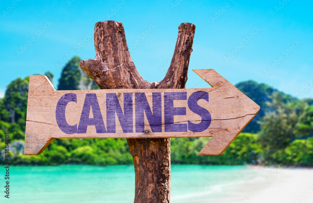 Cannes wooden sign with beach background