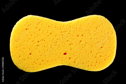 Yellow sponge isolated on the black background photo