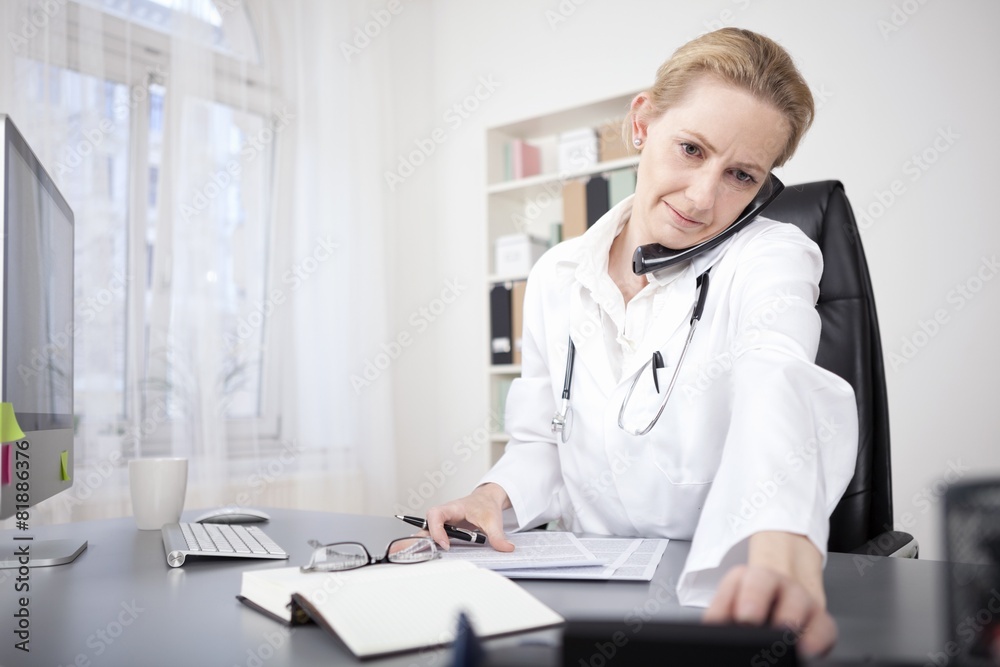 Female Doctor with Phone Between Ear and Shoulder