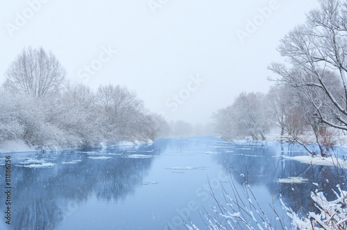 Winter river in snowy weather