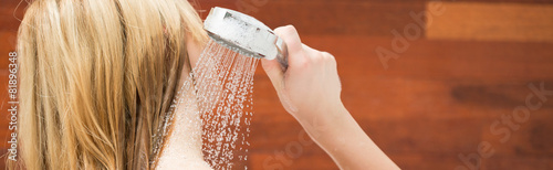 Blonde woman taking a shower photo