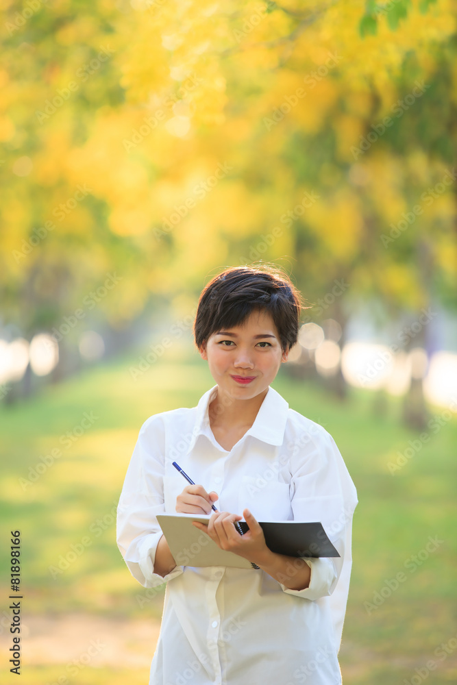 portrait of beautiful asian young woman staning in yellow flower portrait of beautiful asian young woman staning in yellow flower