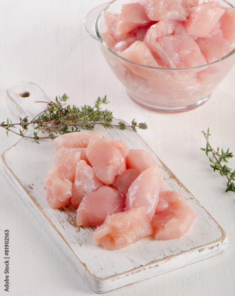 Raw chicken meat on a wooden cutting board. Raw chicken meat on a wooden cutting board.