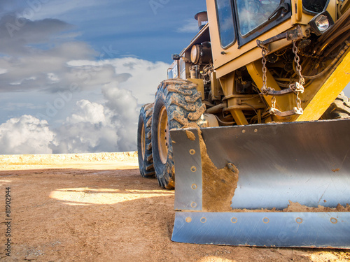 Wheel loader Excavator with backhoe unloading sand at eathmoving