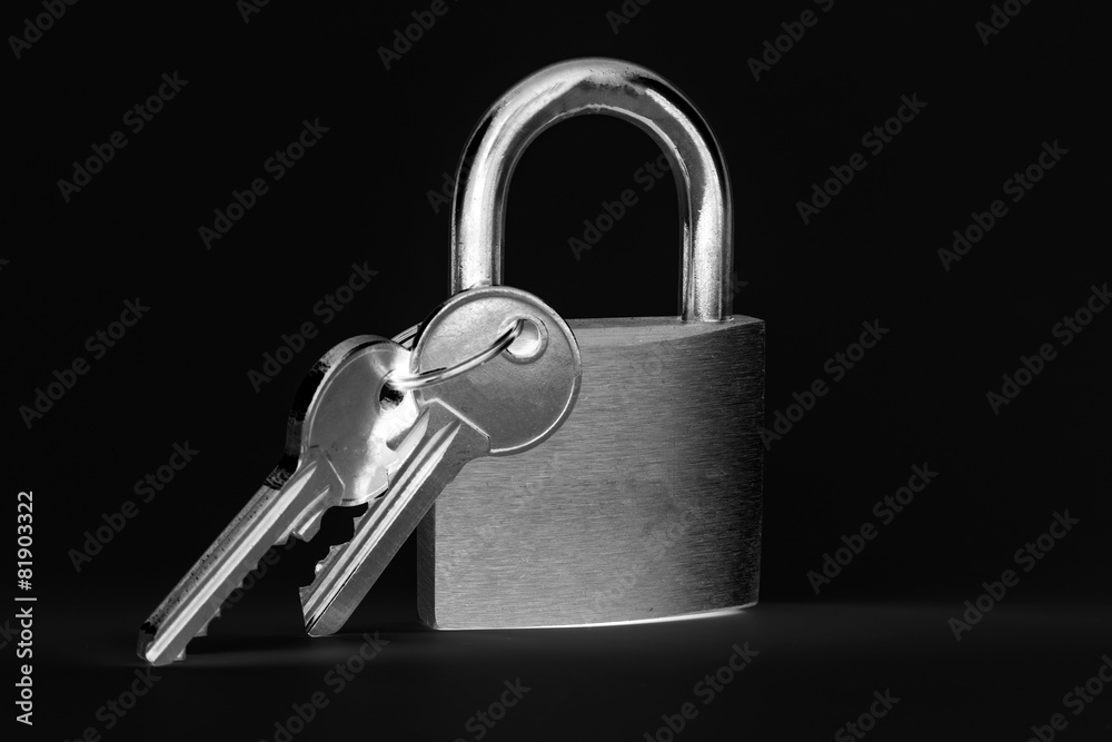 Padlock with keys on a black background Padlock with keys on a black background