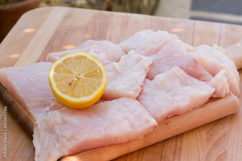fresh fish on wooden cutting board ready for cooking fresh fish on wooden cutting board ready for cooking