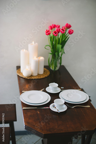   Decorated table with a beautiful bouquet of pink tulips with c