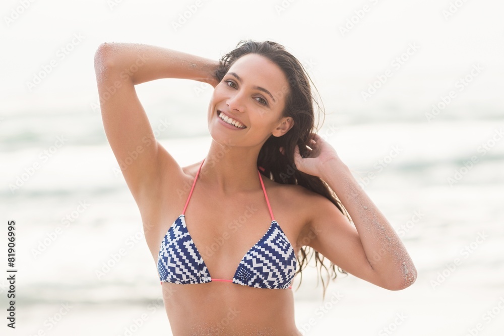 Smiling pretty brunette posing in bikini Smiling pretty brunette posing in bikini