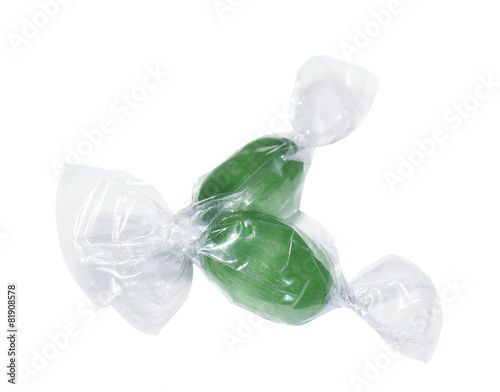 Fotografi Wrapped candies with transparent cellophane isolated on white