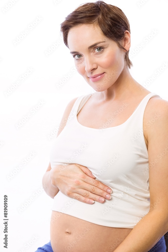 Pregnant woman smiling at camera Pregnant woman smiling at camera