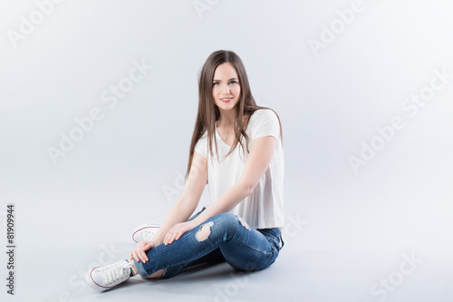 Young girl sitting on the floor