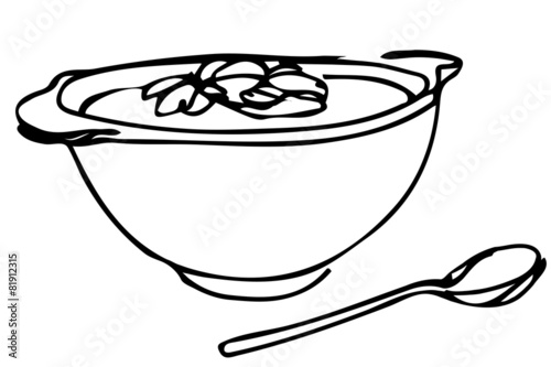 bowl of soup with herbs and spoon lying next