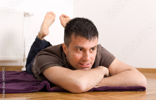 Man lying on stomach on the floor
