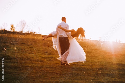 lovely wedding couple in sunset