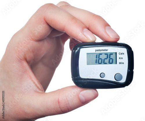 Close-up Of Hand Holding Digital Pedometer On White Background