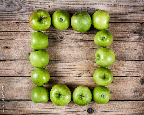 fruit. Ripe green apples on wooden background