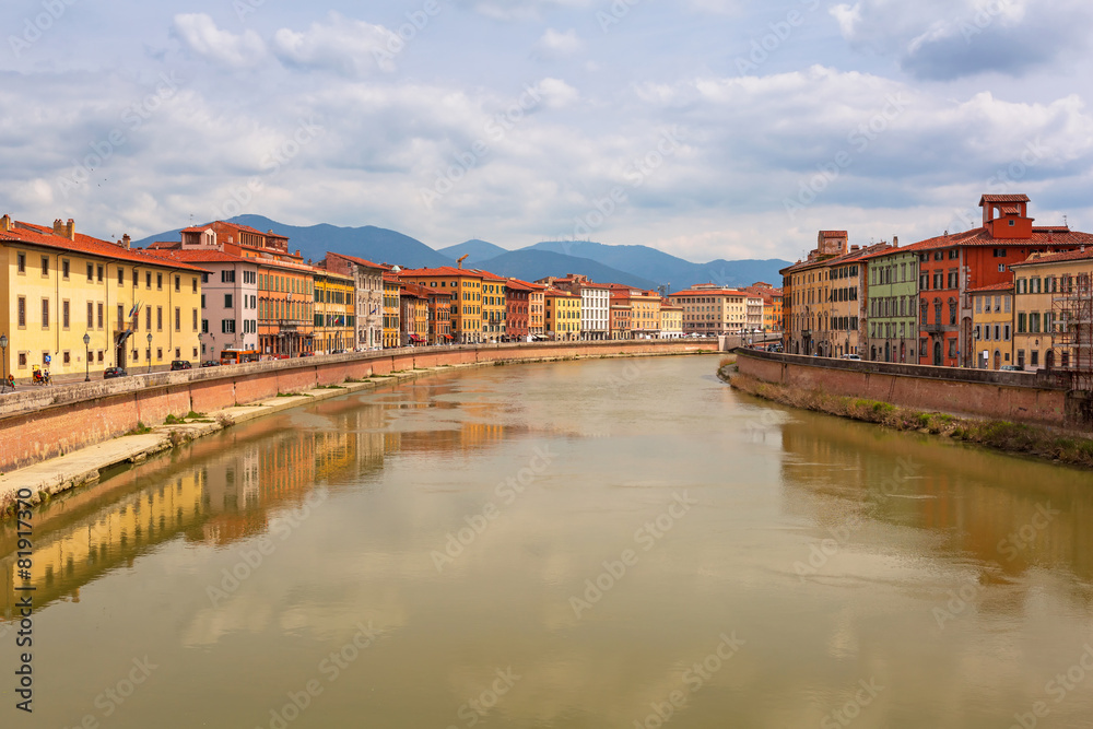 Old town of Pisa with reflection in Arno river, Italy
