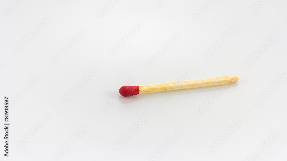 Close up of a red match on a white background Close up of a red match on a white background