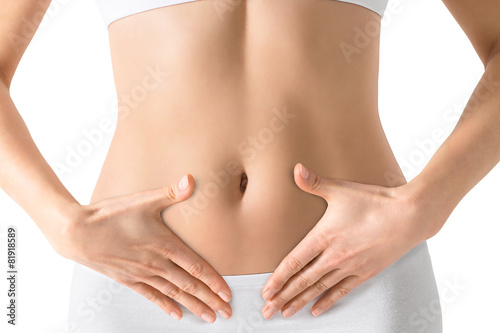 Woman holding hands on a belly. Stomach health concept. Isolated photo