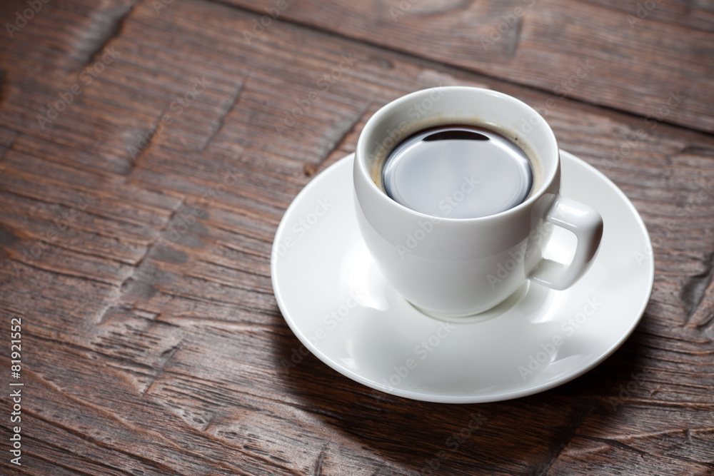 Coffee cup and saucer on wooden table Coffee cup and saucer on wooden table