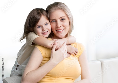 Background. Young daughter closes hands eyes mom - isolated