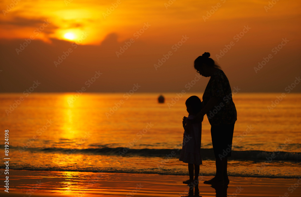 Mother and daughter watching the sunset Mother and daughter watching the sunset