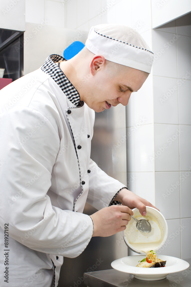 chef preparing food in the kitchen at the restaurant