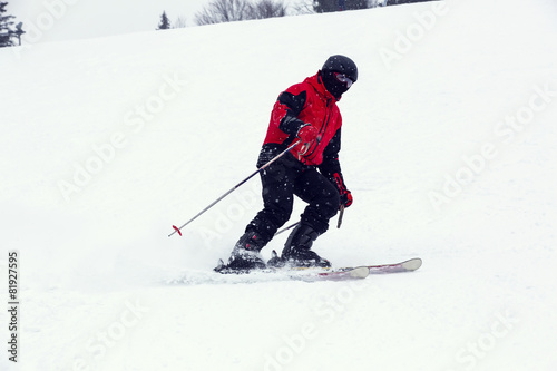 male skier on downhill a steep hill