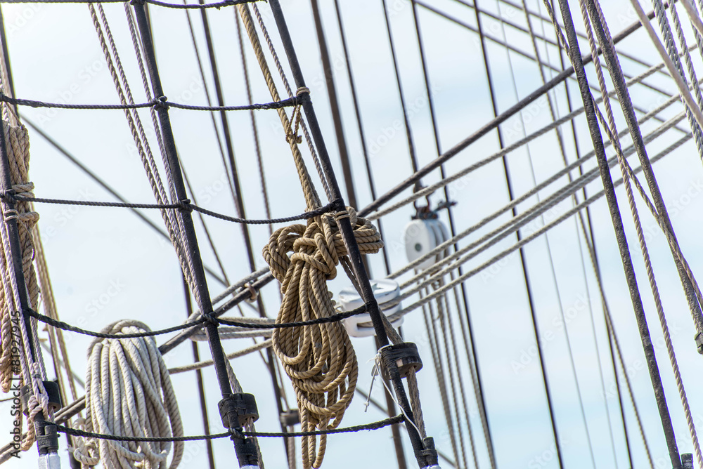 Obraz premium sailboat masts, rigging and rolled up sails