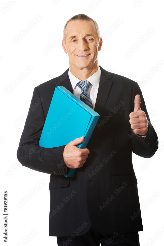 Businessman with ok sign holding a binder Businessman with ok sign holding a binder