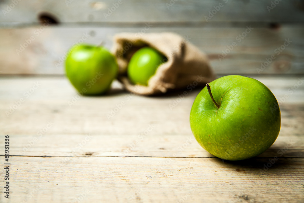fruit. Ripe green apples with burlap, on wooden  background