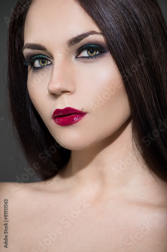 Beautiful young model with red lips and perfect makeup