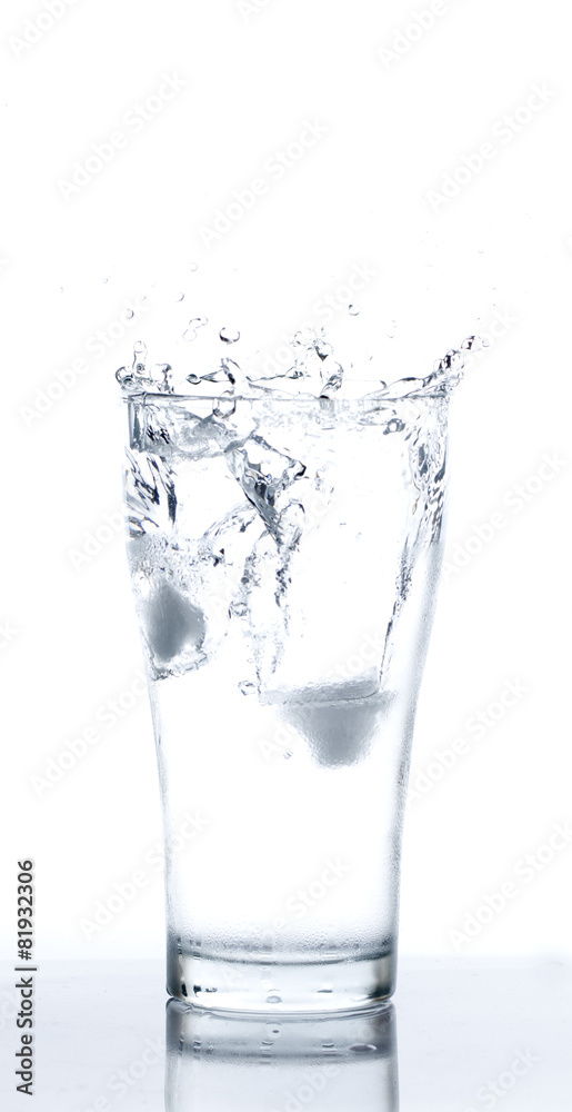 Ice drop into Glass of Water on White background Ice drop into Glass of Water on White background