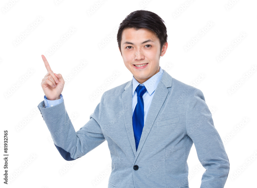 Asian business man smiling and finger pointing up Asian business man smiling and finger pointing up