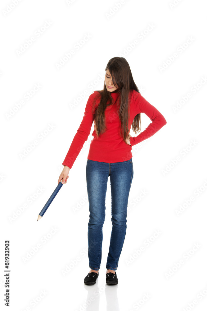 Beautiful woman pointing down with a big pencil. Beautiful woman pointing down with a big pencil.