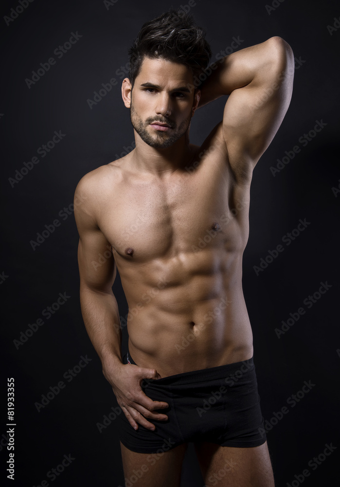 handsome young bodybuilder showing of his fit body and muscles handsome young bodybuilder showing of his fit body and muscles
