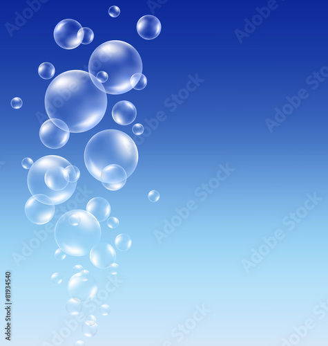 Transparent soap bubbles on blue background